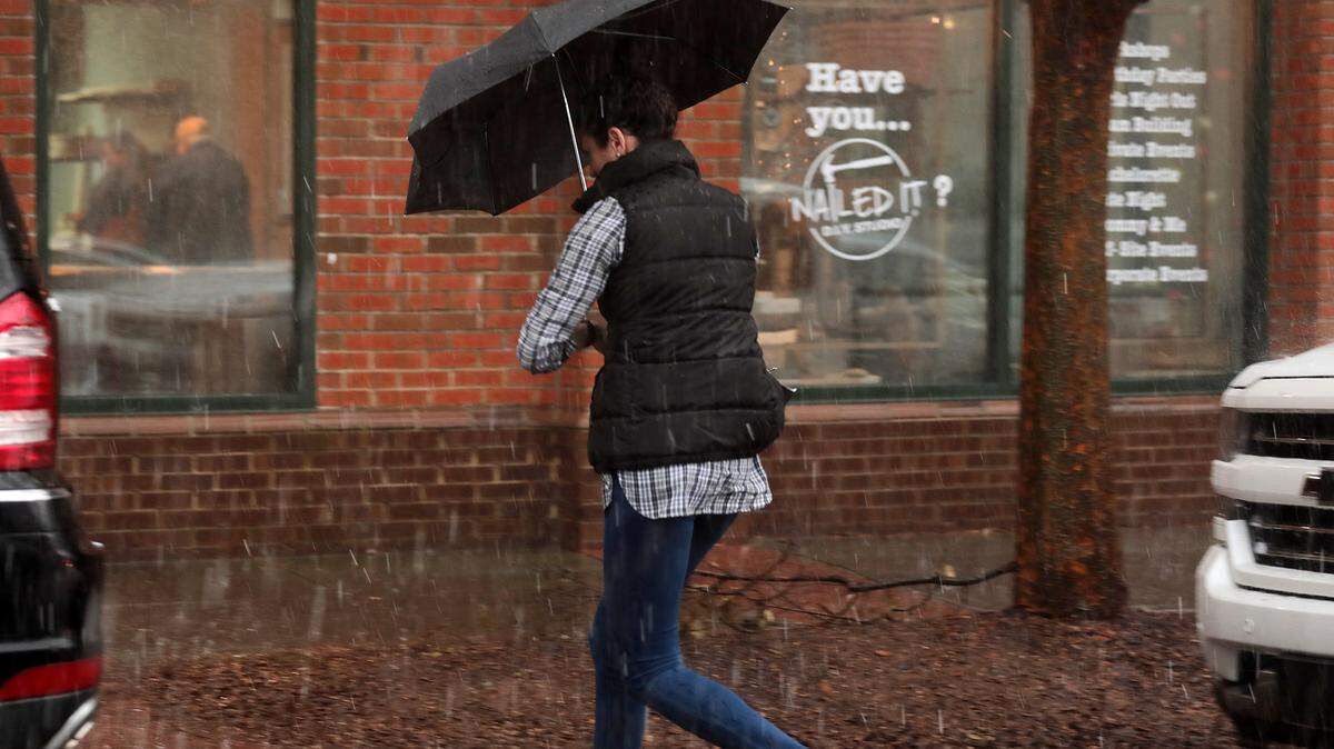 Beth Wigginton runs in the rain in Baxter Village Friday.