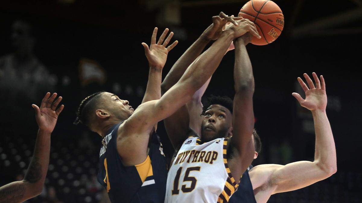 Winthrop’s Jermaine Ukaegbu fights for control with East Tennessee’s Jeromy Rodriguez, left, and Mladen Armus.