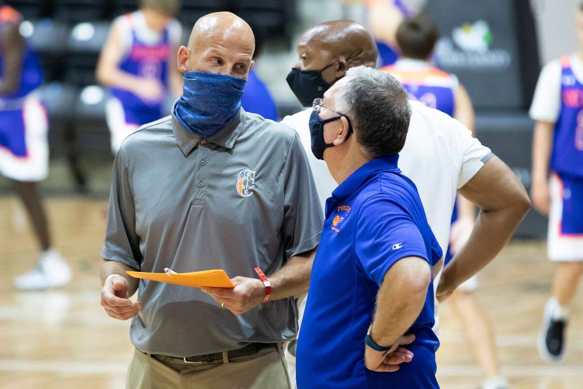 Phenom Hoops Report President Rick Lewis, right, talks with a colleague on Saturday, Aug. 1, in the Rock Hill Sports and Event Center during a tournament he’s running.
