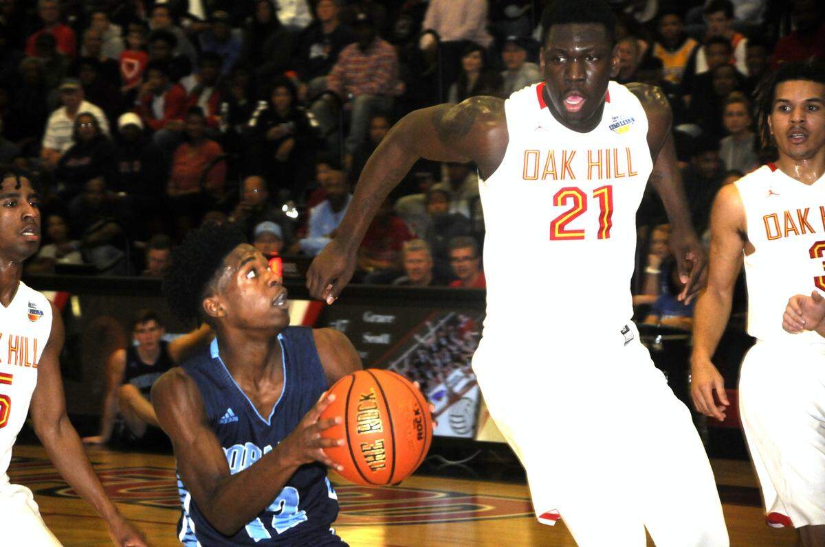 Oak Hill and IMG Academy attracted tons of interest from neutral fans at the 2018 Battle at the Rock basketball tournament at Nation Ford. Oak Hill’s 6-foot-11 center, Kofi Cockburn, readies to swat a Dorman shot during their game.