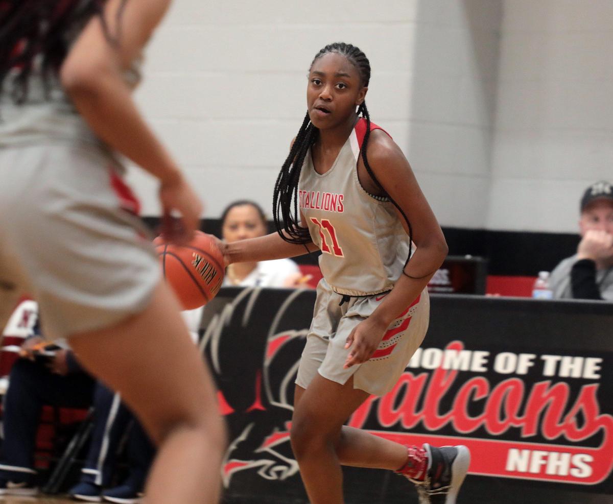 South Pointe’s Najah Lane dribbles the ball up the court Thursday at the Battle of the Rock at Nation Ford High School.