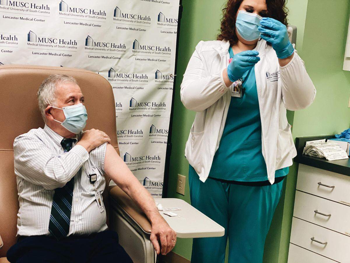 Dr. Howard Snyder, a radiologist who works in close contact with patients, receives the first COVID-19 vaccine at MUSC Lancaster Medical Center.