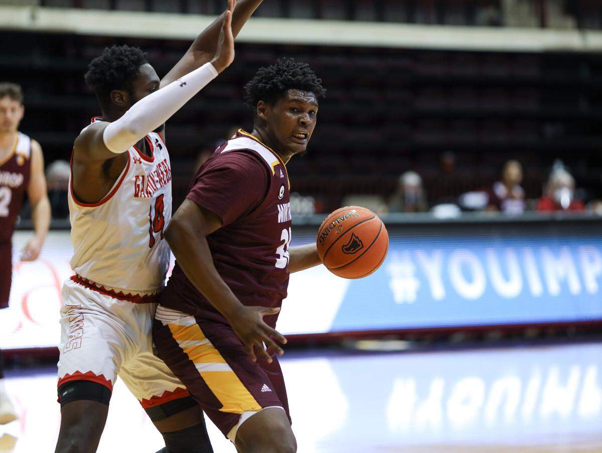 DJ Burns backs down a Gardner-Webb defender Sunday.