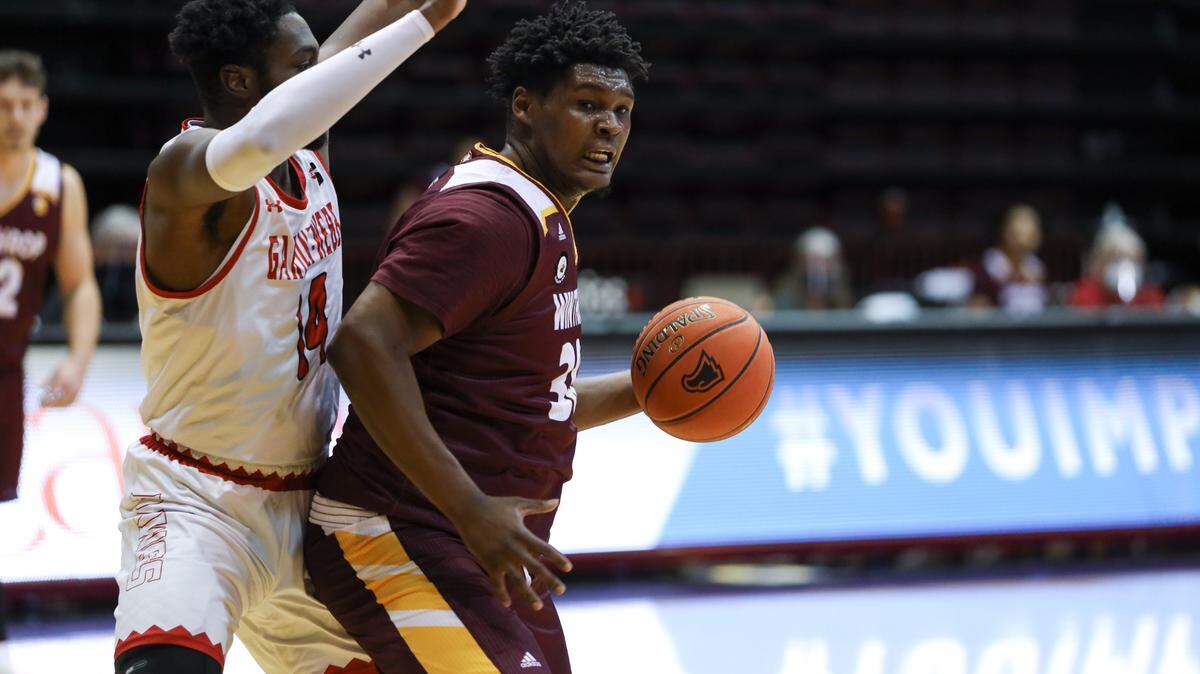 DJ Burns backs down a Gardner-Webb defender Sunday.