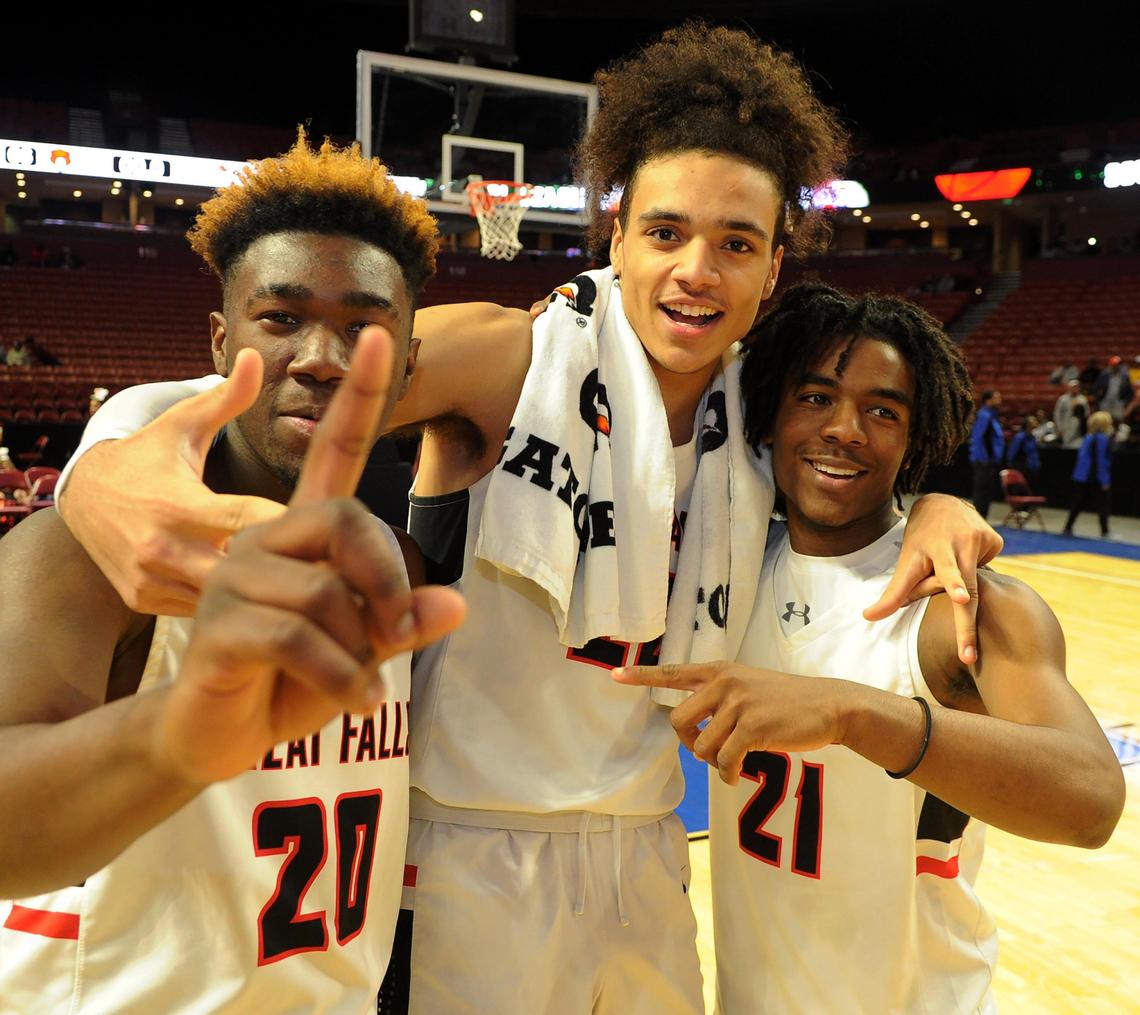 Great Falls’ Quay Bowser (20), Kelton Talford (22) and Xavien Foxx Moore (21) celebrate. Great Falls played High Point for the Upper State Championship at Bon Secours Wellness Arena in Greenville Friday, February 28, 2020.