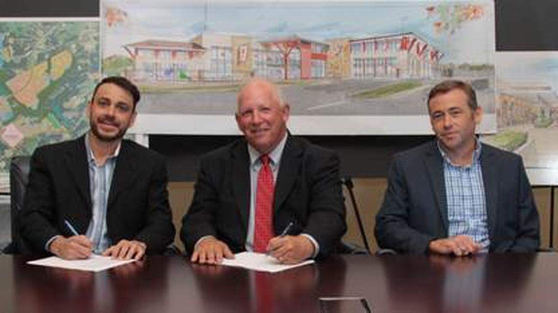 CrossRidge Development Vice President Melissa Prince and COO Ben Cerullo join Upper Palmetto YMCA CEO Frank "Moe" Bell, board chair Toby Chrisley and COO Erika Bell in signing an agreement to bring a new YMCA to Indian Land.