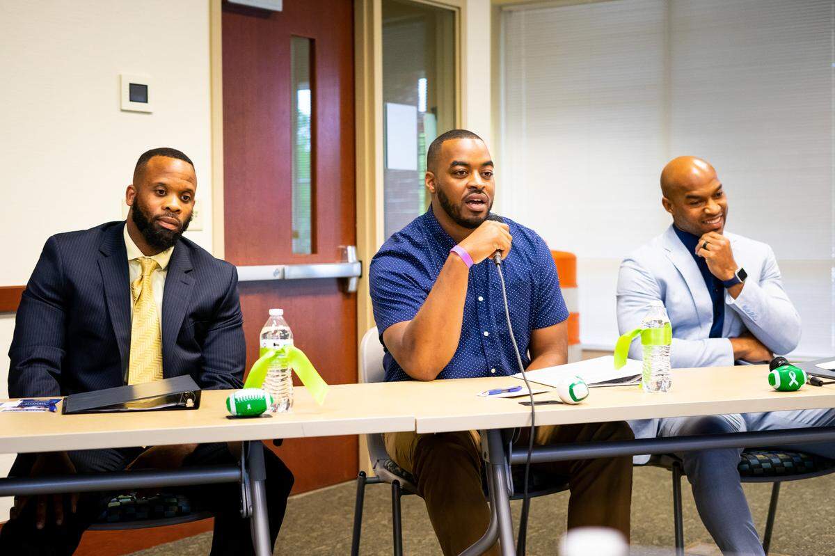 Three football players from Rock Hill — Najee Sutton (left), DeVonte Holloman (center), Chris Hope (right) — speak at an event about football and their personal struggles with mental health. Holloman specifically mentioned his sister at the May 2021 event.