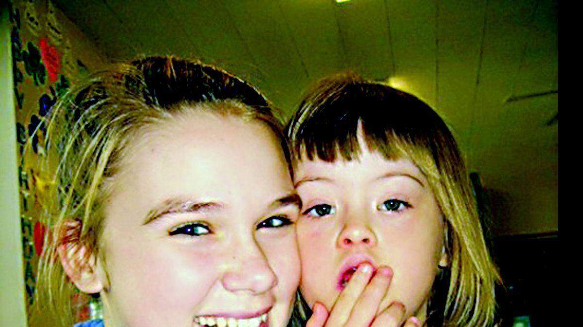 Carrie Holt, left, and Kayla Clements attend a meet-your-buddy event at Myers Park United Methodist Church in Charlotte last October. Holt and 5-year-old Kayla, who has Down's syndrome, met through Playing for Others, a Charlotte non-profit group that gives creative-minded youths a chance to make a difference in their community. Below, the pair take part in the 2007 Buddy Walk.