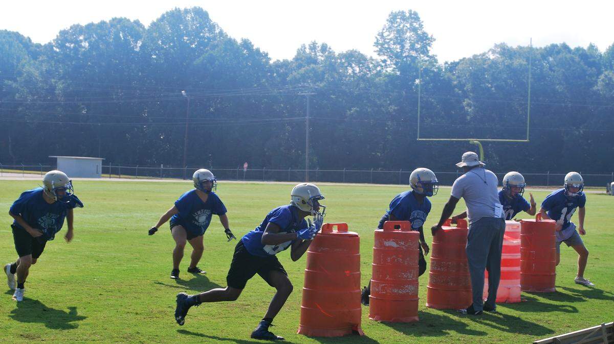 Members of the Lewisville Lions run line drills during a recent practice.