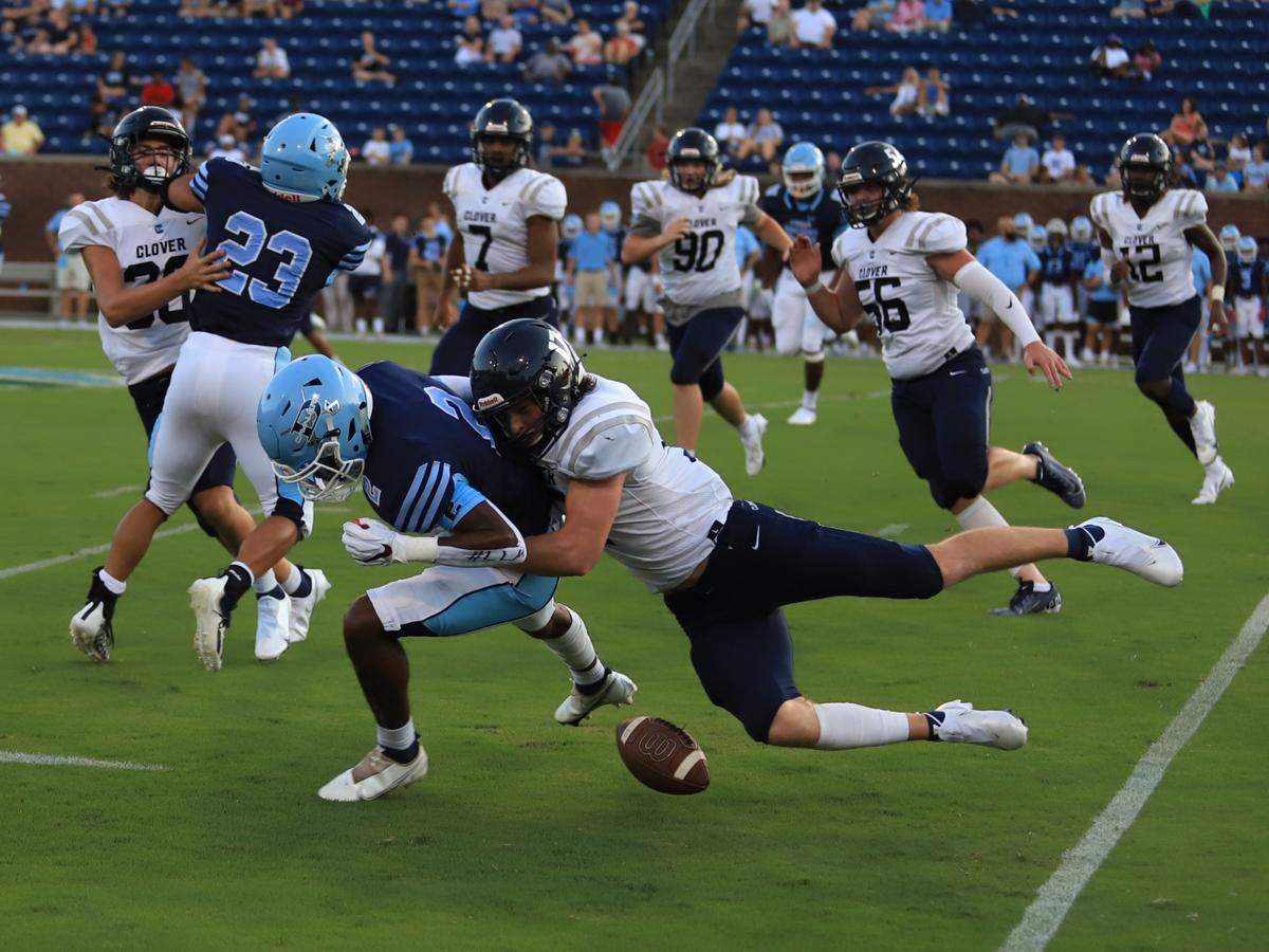 Clover’s Cooper Zohner, right, jars loose a fumble that is then recovered and taken in for a Blue Eagles touchdown.