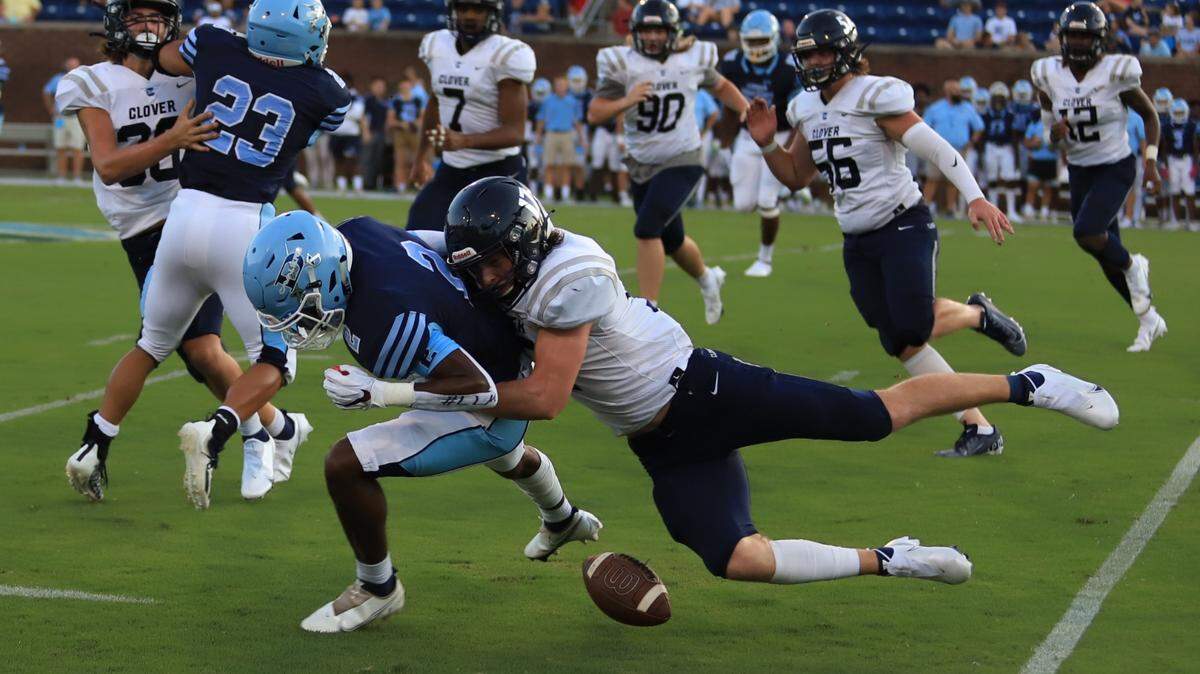 Clover’s Cooper Zohner, right, jars loose a fumble that is then recovered and taken in for a Blue Eagles touchdown.