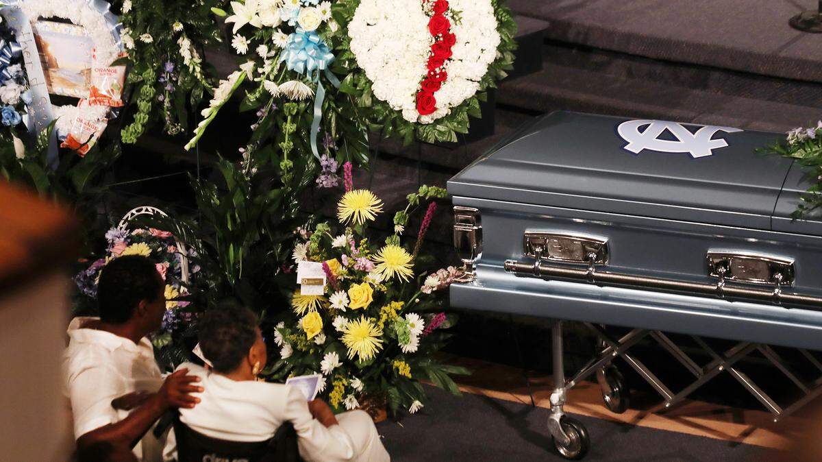 Members of the late Charles Latta’s family  listen during his funeral at West End Baptist Church.