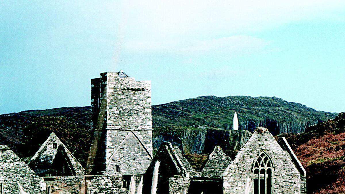This abbey ruin is on Sherkin Island. The Baltimore Beacon is visible in the distance across the Ocean on the mainland; it's the white tower just to the left of the abbey roof over the large window.