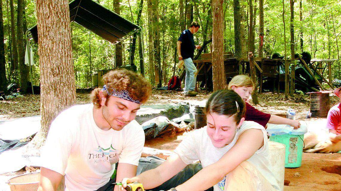 Robin W. Smith and Emily Cubbon, students at UNC-Chapel Hill, measure the depth of the dig at the Kanawha site. About 15 university professors, students and some volunteers set up camp in June at Nassaw Town, once the home of about 200 to 300 people and about 50 native American warriors.