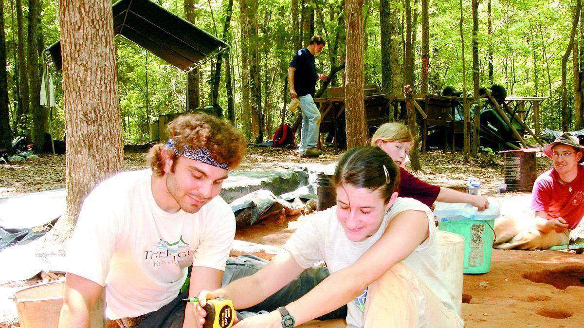 Robin W. Smith and Emily Cubbon, students at UNC-Chapel Hill, measure the depth of the dig at the Kanawha site. About 15 university professors, students and some volunteers set up camp in June at Nassaw Town, once the home of about 200 to 300 people and about 50 native American warriors.