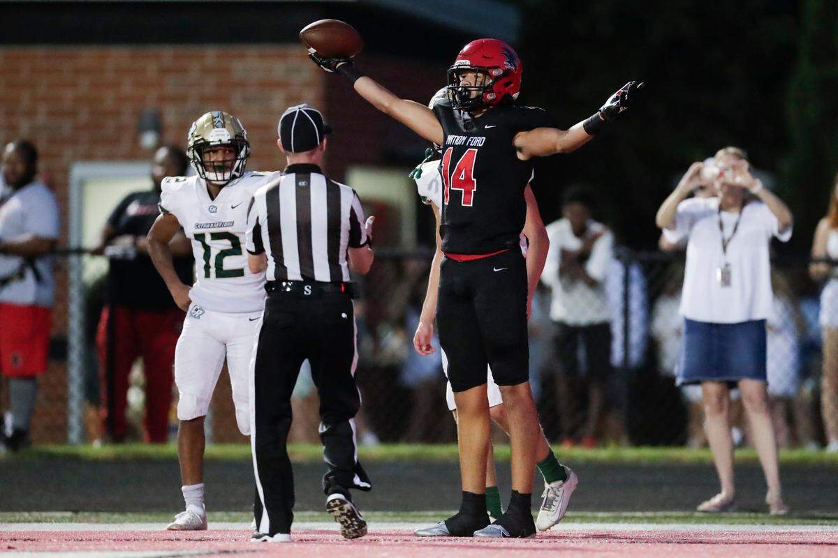Nation Ford’s (14) Brooks Johnson celebrates a touchdown in first half play as Nation Ford hosts Catawba Ridge in a Friday night cross town football rivalry, 8-27-2021.