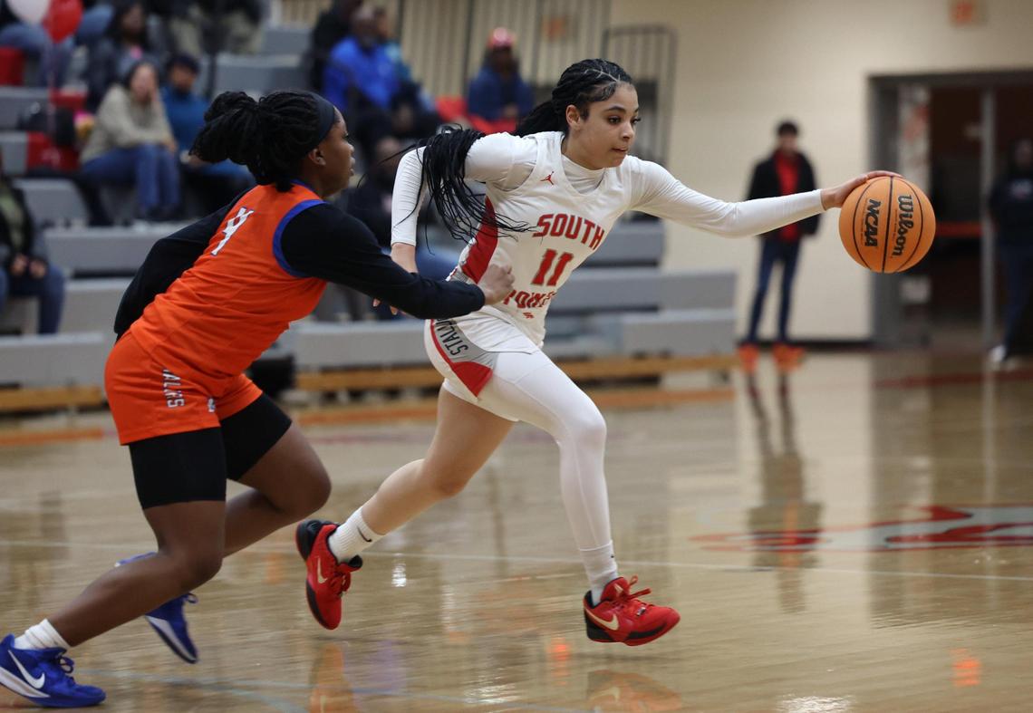 South Pointe’s Serenity Woods moves past Richland Northeast’s Latia Ray Thursday in Rock Hill.
