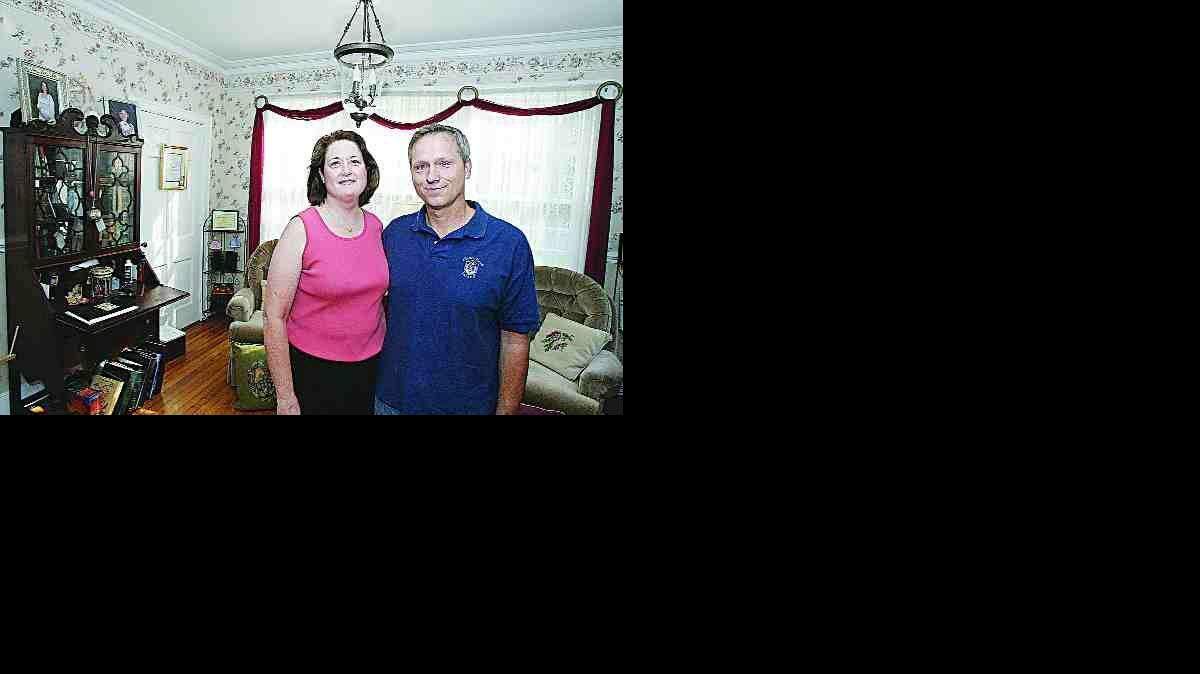 Freddy and Pam Schronce stand Thursday in the parlor of their home at 3 W. Madison St. in York, the former home of E. Gettys Nunn, the probate judge who married Schronce's parents and grandparents. Freddy Schronce, a notary public, will officiate his cousin's wedding there today.