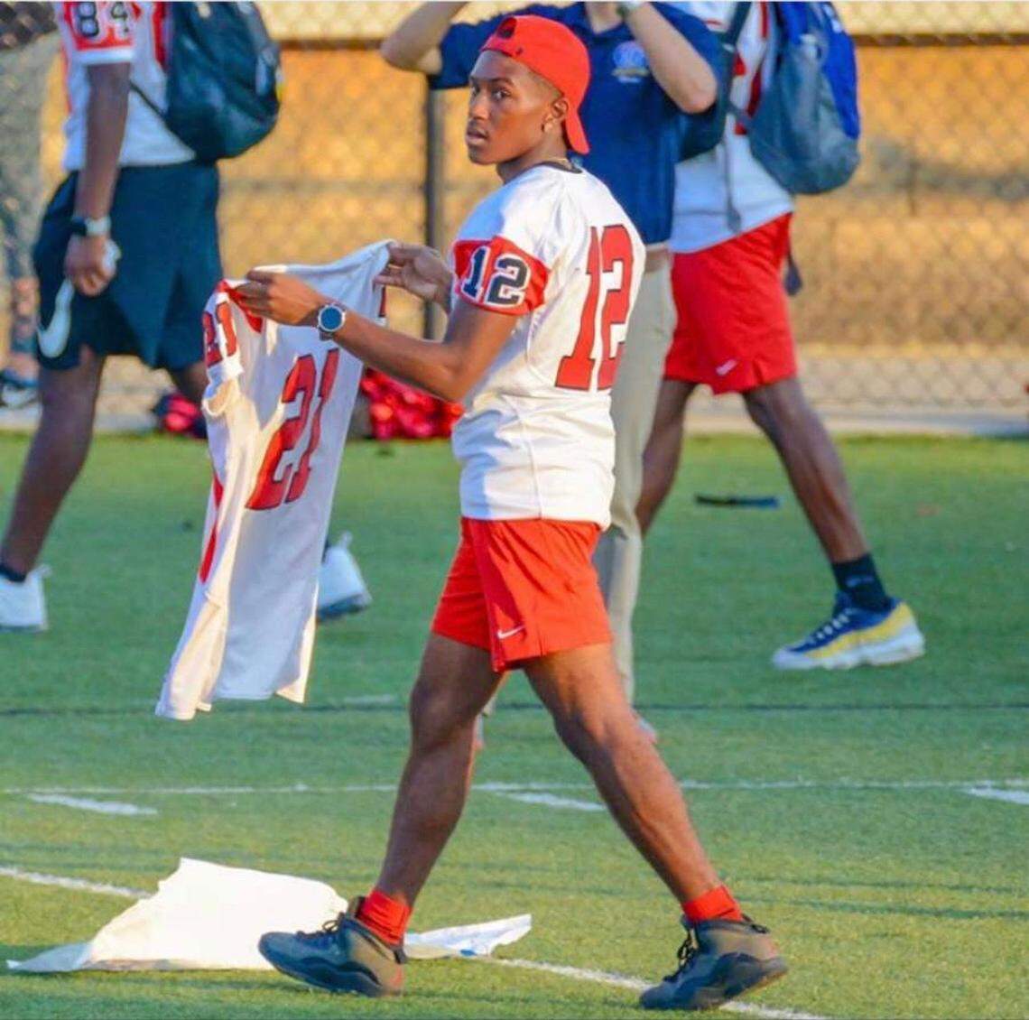 Raseac Myles carries Savion White’s jersey out to the field prior to a South Pointe football game this season.