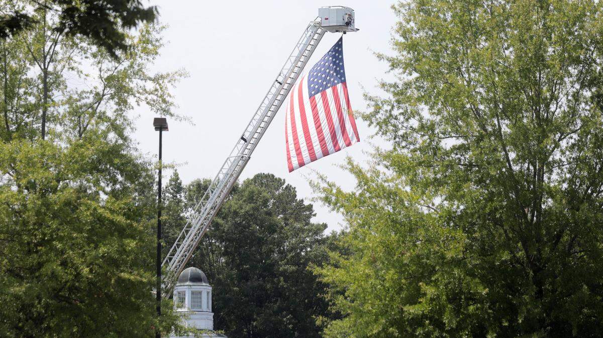 A large American flag flies from a fire engine at the funeral of Lt. Larry Vaughan.