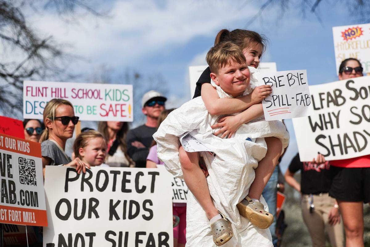 John Grigg, 10, and his sister Juliana, 7, attend the Move Silfab protest against Silfab Solar at Walter Elisha Park in Fort Mill.