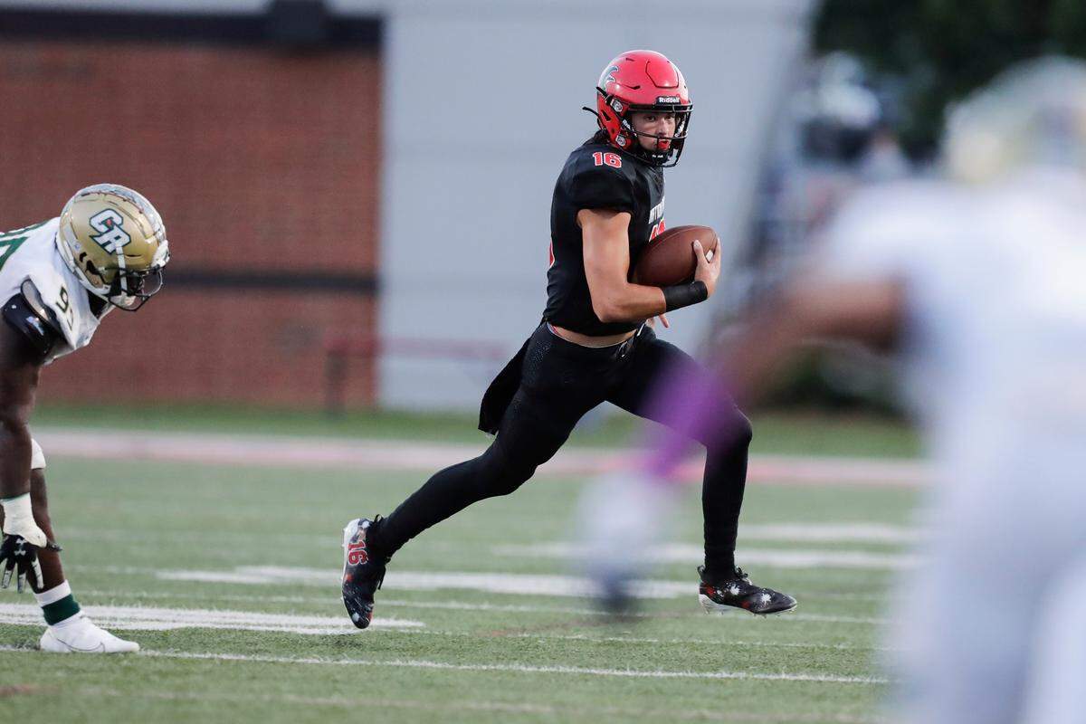 Nation Ford quarterback (16) Carson Black keeps the ball in first half play as Nation Ford hosts Catawba Ridge in a Friday night cross town football rivalry, 8-27-2021. The Falcons play Clover in their regular season finale Friday (Oct. 29).