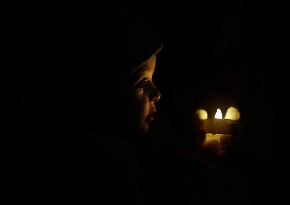 2-year-old Mary Carter Dixon watches the opening ceremony of ChristmasVille Thursday evening in Rock Hill.