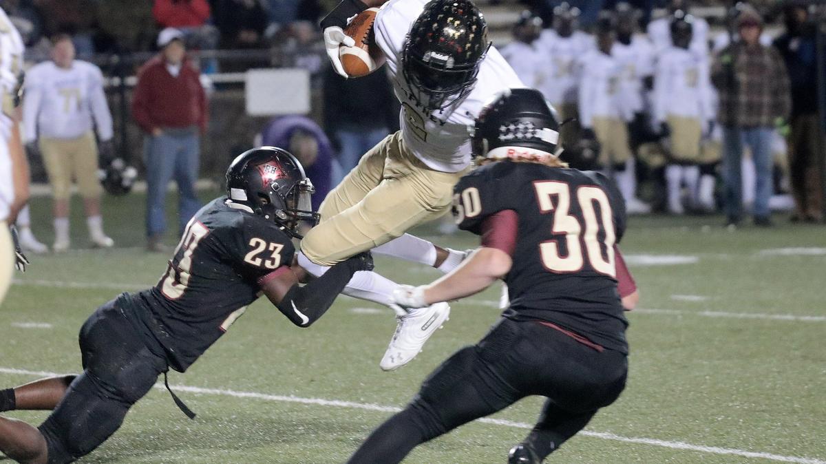 Gaffney’s Demari Littlejohn is tackled by Rock Hill’s Regan Chisolm (23) and Jeffery Patterson.
