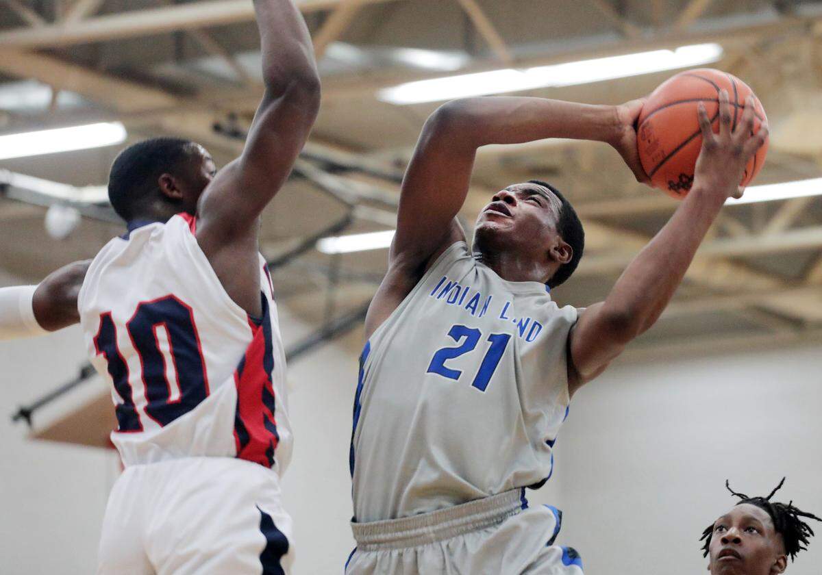 Indian Land’s Omarion Foster heads to the basket as Chester’s Jordan Coleman defends Friday at Chester High School.