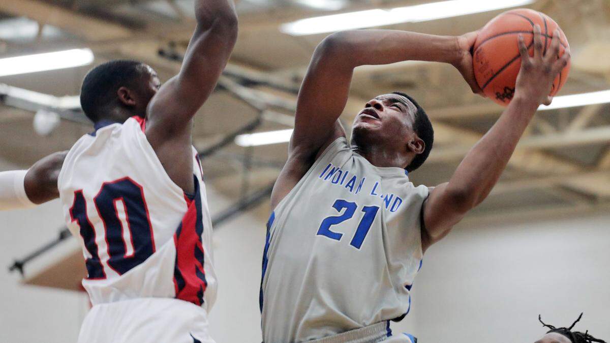 Indian Land’s Omarion Foster heads to the basket as Chester’s Jordan Coleman defends Friday at Chester High School.