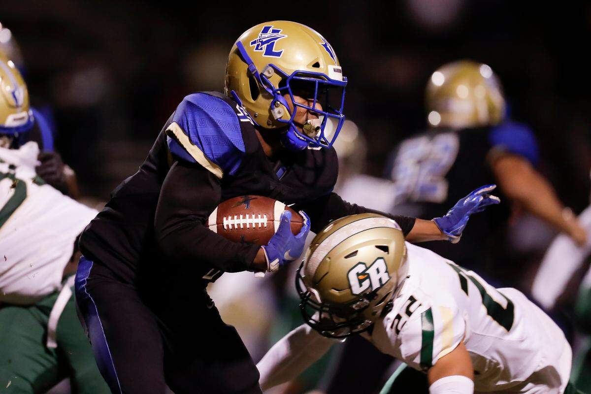 Indian Land’s #4 TJ Thomas carries the ball in early play as Indian Land hosts Catawba Ridge in Friday night varsity football. 0-16-2020.