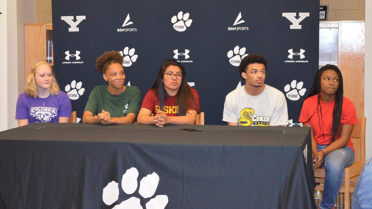 York Comprehensive High School seniors (from left) Jessie Durflinger, Mikali Smith, Elia Sosa, Malcolm Kennedy and Amiyah Starnes all signed agreements to continue their athletic careers in college on April 25, 2018.
