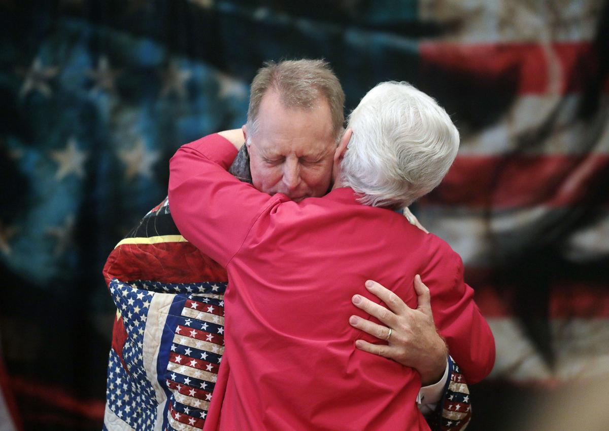 Sen. Mike Fanning, D-Great Falls, cries as he receives a Quilt of Valor Monday from Linda Mayhill. More than a dozen Quilts of Valor were given to veterans at the Veteran’s Day Commemoration ceremony at the Chester War Memorial building.