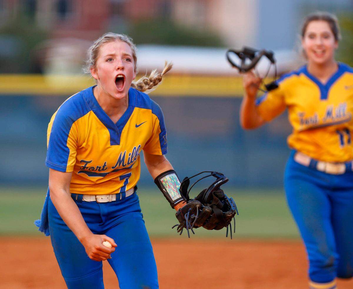 Fort Mill’s Maddie Drerup (7) and Vicki Lott (11) celebrate during the class 5A softball championship final game.