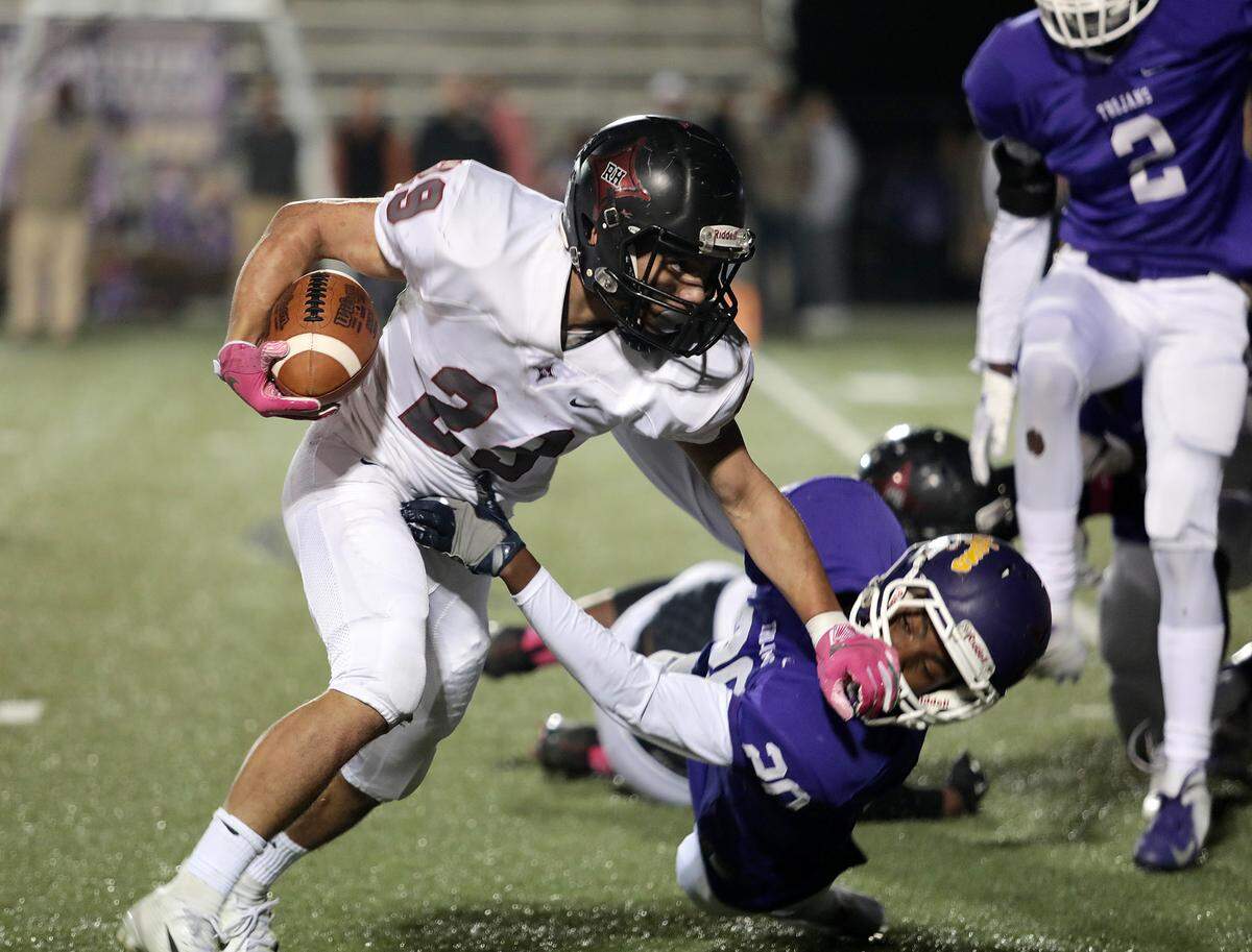 Rock Hill’s Noah Thompson carries the ball against Northwestern’s Zy’Quon Edwards in the rivalry game on Oct. 25, 2018.