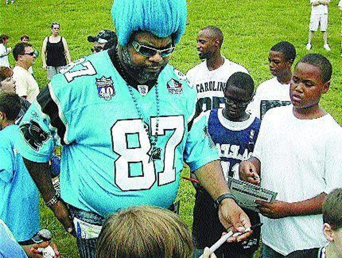 In this 2006 Charlotte Observer file photo, Greg “Catman” Good of Winston-Salem signs autographs for young Carolina Panthers fans at training camp in Spartanburg, S.C. People often asked Good for his autograph, even though he was simply a fan. He sometimes took more than 100 photographs per game with other fans, his son said.