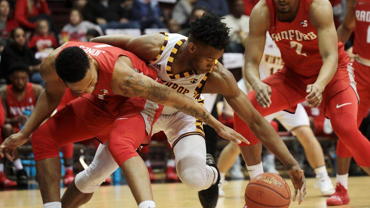 Winthrop’s Jermaine Ukaegbu fights for control with Radford’s Carlik Jones, left, and Tristan Owens.