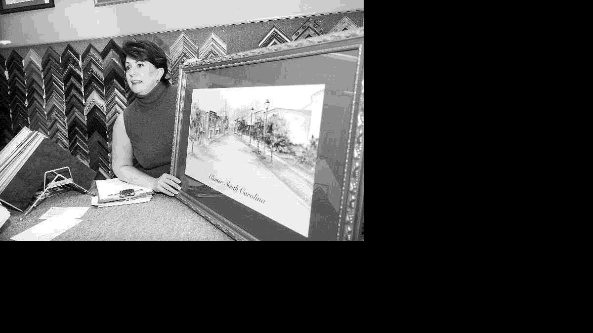 Dale Barattini, artist and owner of Gallery 108, shows one of her prints.