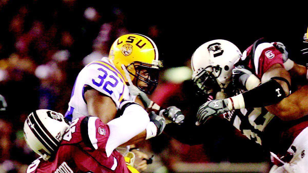 USC linebacker Eric Norwood (40) pulls down LSU running back Charles Scott with help from fellow linebacker Jasper Brinkley during the first quarter Saturday at Williams-Brice Stadium in Columbia.