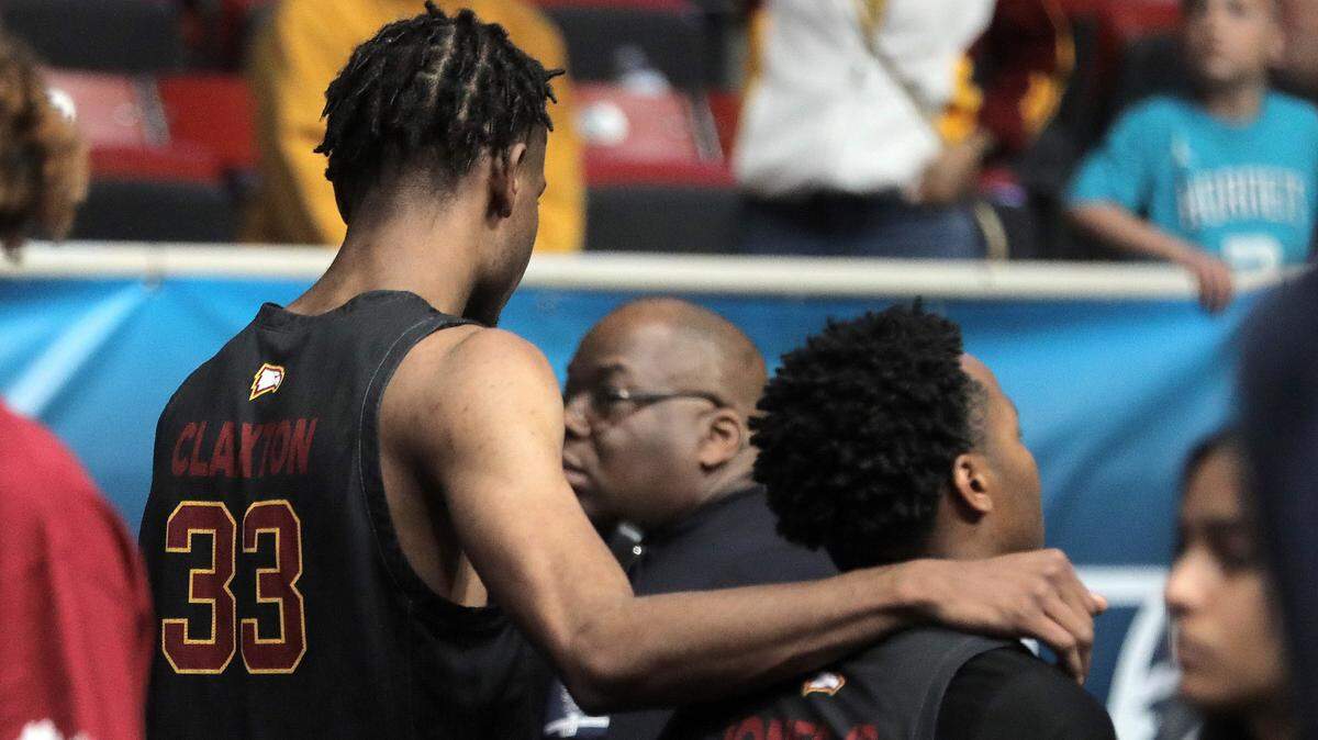 Winthrop’s Chase Claxton, left, and Russell Jones Jr. walk out of the stadium after being defeated by Longwood Sunday at the Big South Championship game.