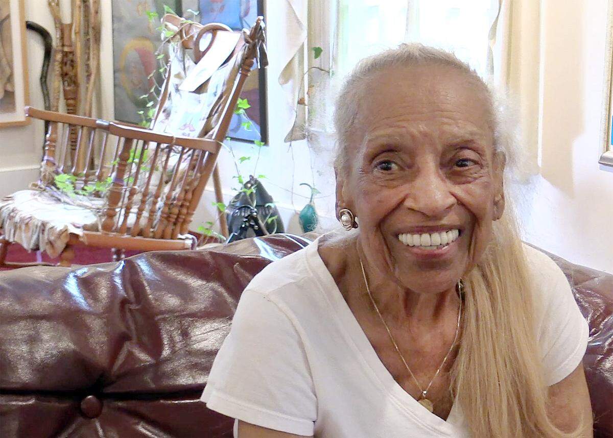 Vivian Ayers Allen sits in front of a rocking chair that belonged to the wife of her former principal at Brainerd Institute in Chester. A vine from outside the window has grown around the chair, which Ayers Allen wants to remain intact.