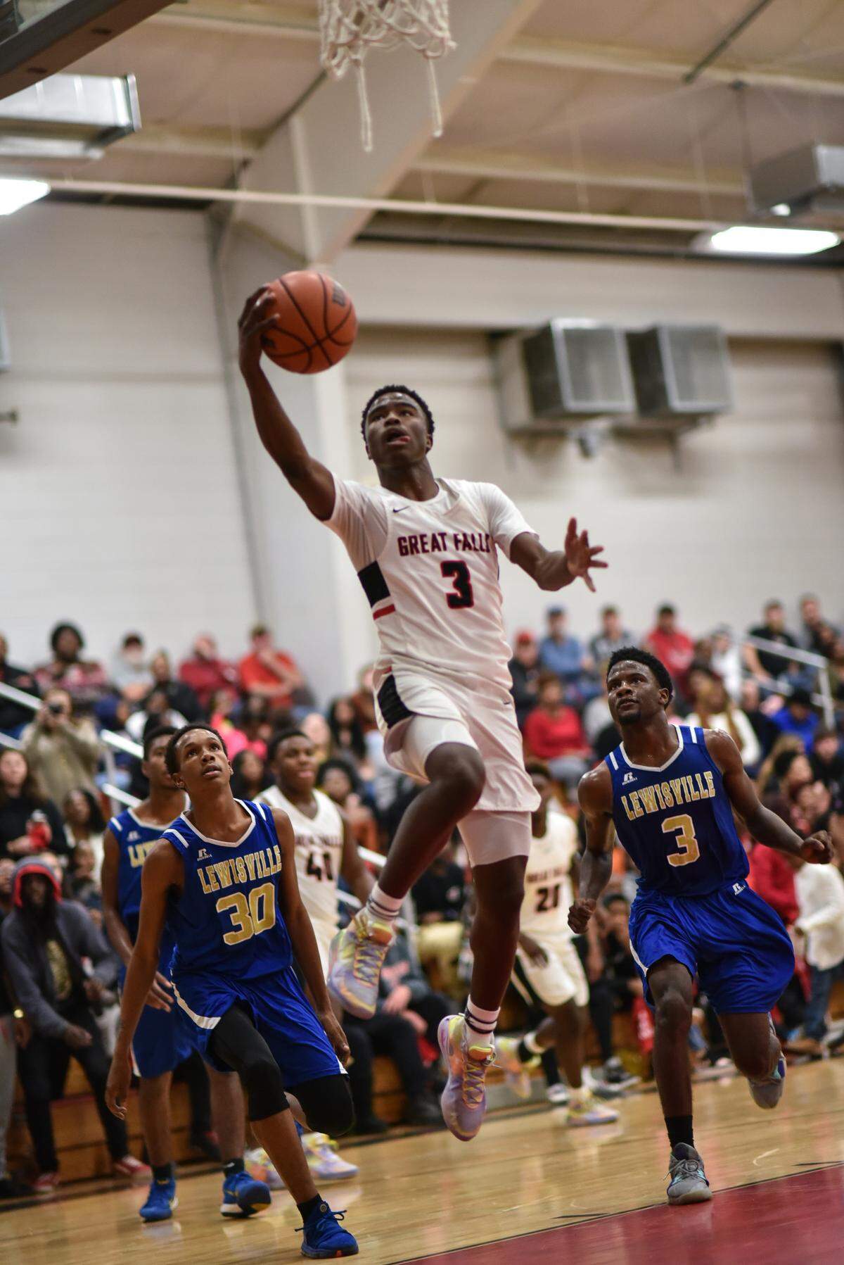 Great Falls’ DJ Adams scores for the Red Devils Tuesday night at home against rival Lewisville. Great Falls defeated Lewisville 67-55.