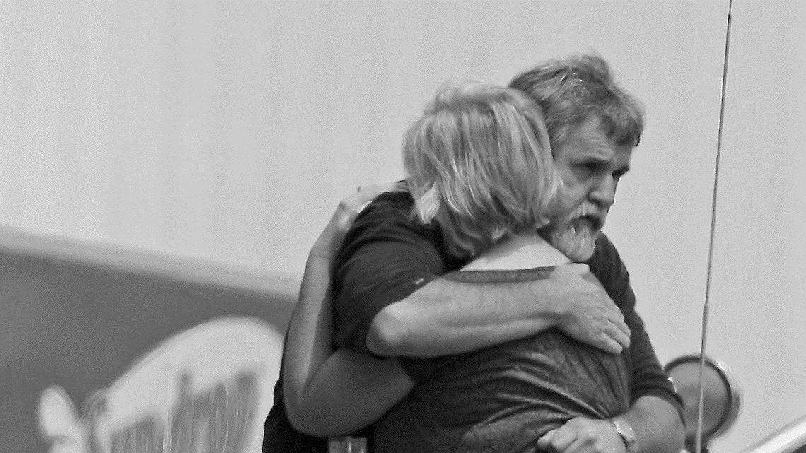 Two people embrace outside a Sun-drop bottling plant in Concord, N.C., where officials say two people were shot and killed Friday morning during an apparent robbery.