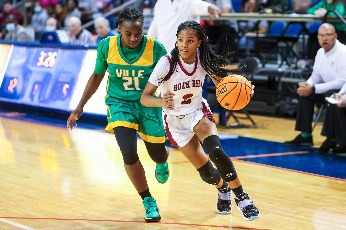 Rock Hill Bearcats Alyssa Hankerson (2) drives past Summerville Green Wave Jehmyah Chisolm (21) in the first half of the Girls 5A State Championship Game at the University of South Carolina Aiken Thursday, March 3, 2022.