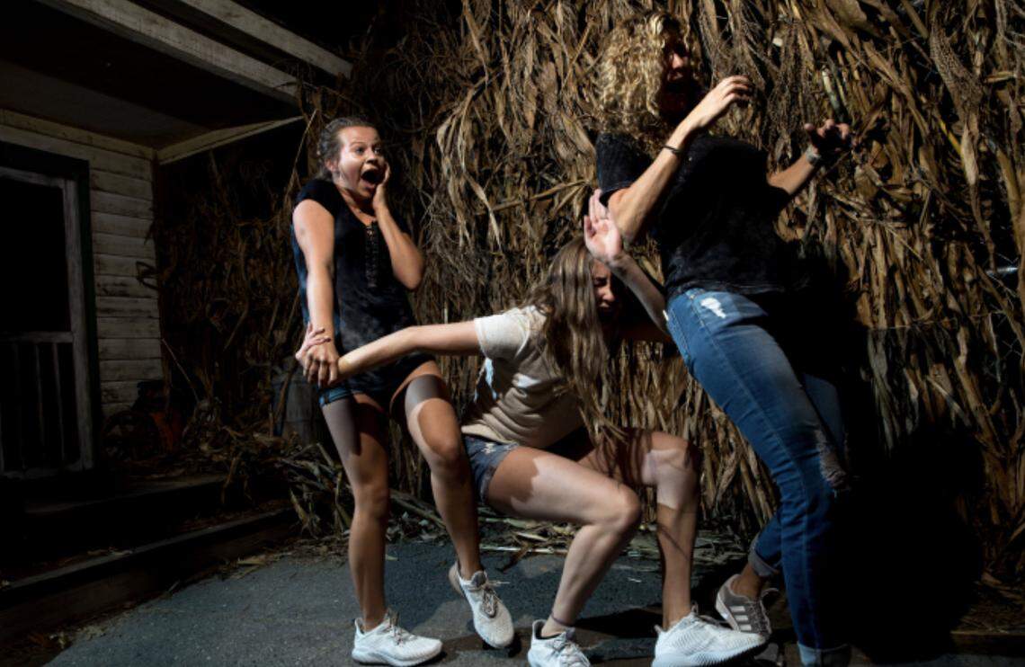 Carowinds visitors in a haunted maze, part of the Scarowinds event.