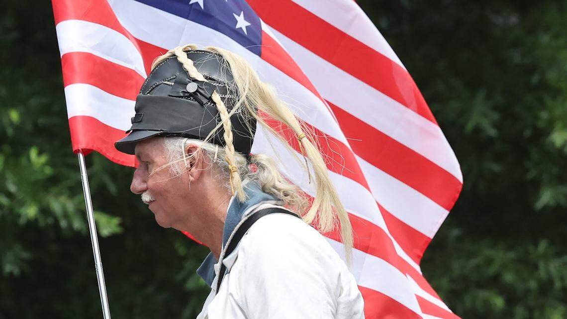 Dean Withers holds an American flag Saturday, June 14, 2025 at a protest in downtown Rock Hill.