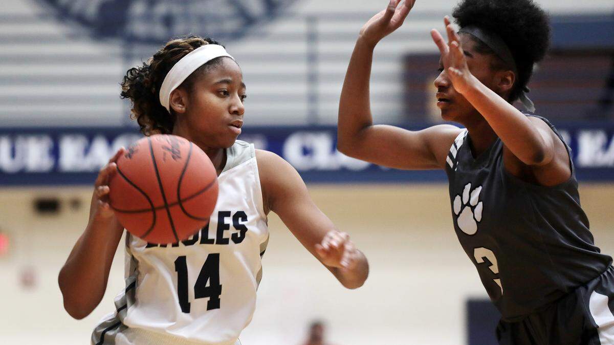 Clover’s Tiona Walls drives to the basket around York’s JaLeah Long.