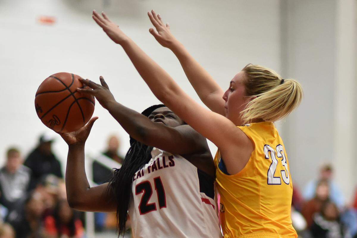 Lewisville’s Allie Keels guards Great Falls’ Donnasia Caldwell Tuesday night at Great Falls.