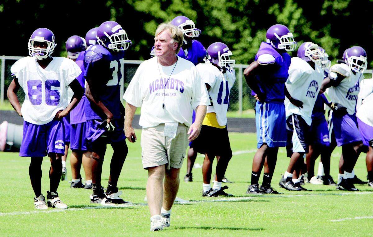 Herald file (2008): Northwestern coach Jimmy Wallace leads practice in a 2008 practice, two state championship losses before the Trojans were finally crowned in 2010.
