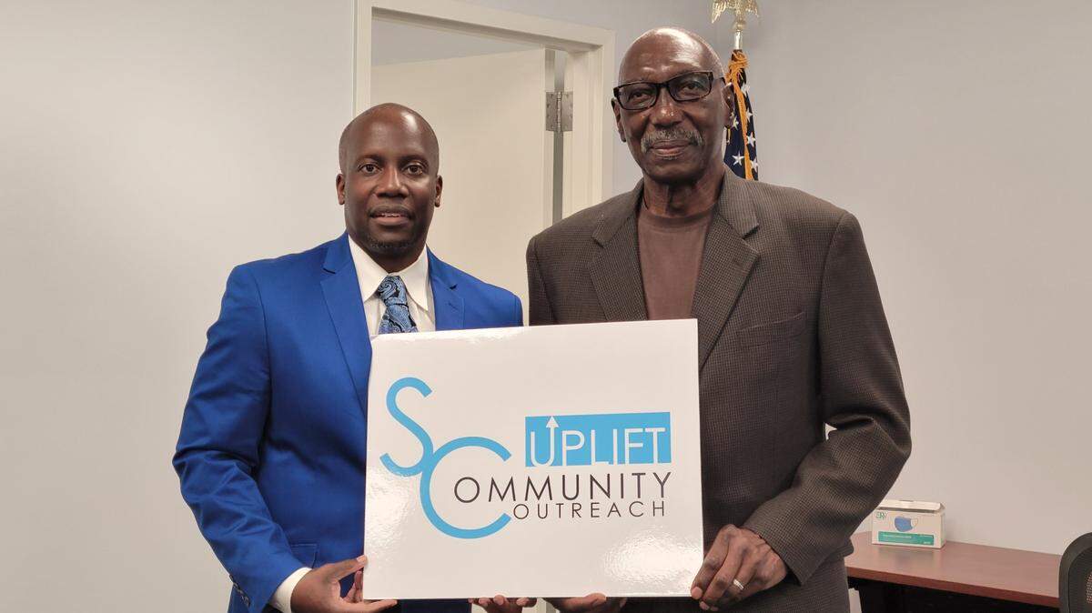 Kevin E. Wemberly, CEO of SC Uplift Community Outreach and Joseph E. Gardner, board president, celebrate receiving the HUD grant.